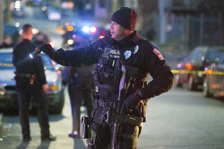 Harrisburg Police block off sections of the street after a shooting, Friday, Dec. 22, 2017. A prosecutor says there's "no doubt" a gunman who fired at police in several locations in the capital city before they shot and killed him was targeting police officers. Authorities say Ahmed Aminamin El-Mofty fired at a Harrisburg police officer on Friday afternoon and later at a state trooper, wounding her. They say he later approached police with two handguns and fired many shots at them before they returned fire and killed him.