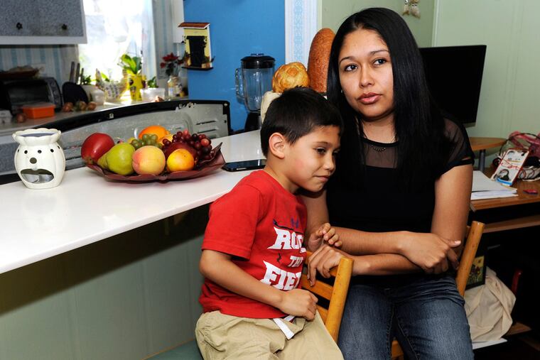 Libia Rodriguez and son Bryan Bravo at their Coatesville home. Rodriguez and her husband are in the U.S. illegally; their three children, born in the U.S., are citizens.