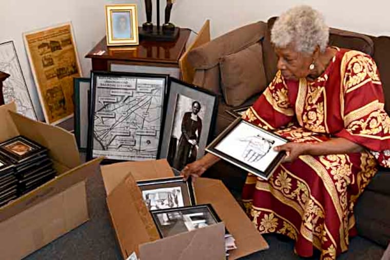 Louise Calloway sits among artifacts relating to the Underground Railroad. Burlington
County College is creating a space to display the collection. TOM GRALISH / Staff Photographer