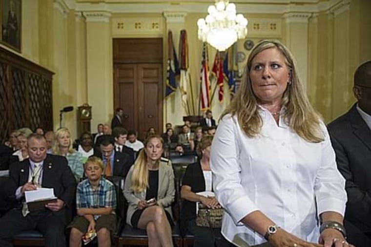 Kristen Ruell, authorization quality review specialist, Pension Management Center, Veterans' Affairs Philadelphia Regional Office, waits at the witness table to testify to the House Committee on Veterans' Affairs hearing to review the Veterans Benefits Administrations progress in achieving VA's goal of ending its disability compensation claims backlog by 2015, on Capitol Hill in Washington, Monday, July 14, 2014. (AP Photo/Cliff Owen)