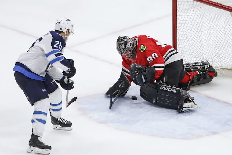 Chicago Blackhawks goalie Scott Foster (90) defends against Winnipeg Jets center Paul Stastny (25) during the third period of the Blackhawks’ win on Thursday.