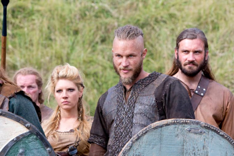 This image released by History shows Katheryn Winnick, as Lagertha, left, Travis Fimmel, as Ragnar, center, and Clive Standen as Rollo in a scene from "Vikings," premiering Sunday, March 3 on History. (AP Photo/History, Jonathan Hession)