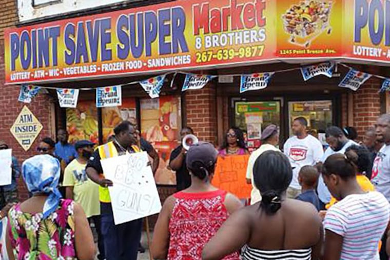 Protesters gathered outside a corner store over the sale of airsoft guns. The owner agreed to stop selling the toy. (Jenice Armstrong/Staff)