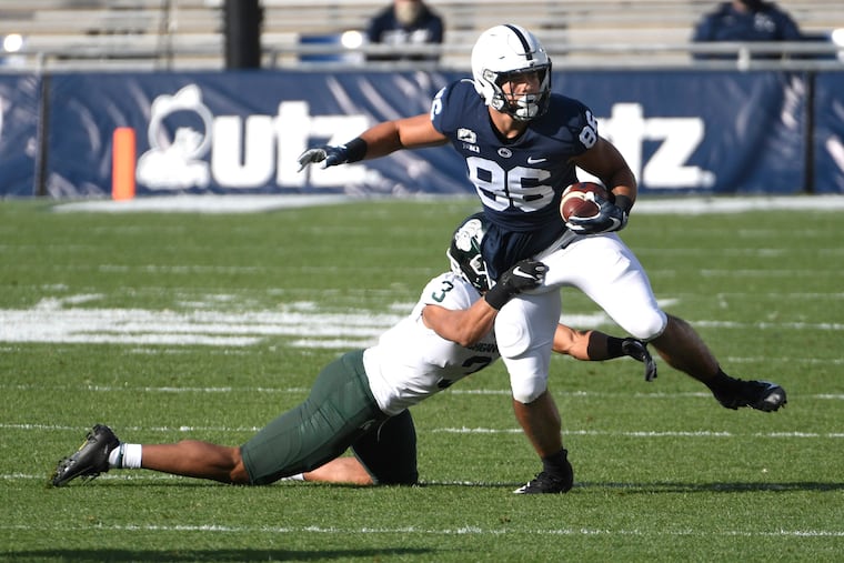Penn State tight end Brenton Strange attempts to break a tackle attempt by Michigan State safety Xavier Henderson during their game on Dec. 12.