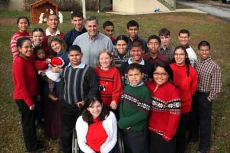 John and Donna Kurtz, center, with all of their adopted children at their home and school in East Fallowfield Twp, Chester County. (Laurence Kesterson / Staff Photographer)