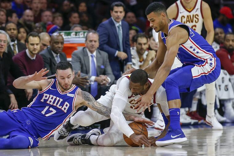 Cavaliers guard Dwyane Wade goes after a loose ball with Sixers guard JJ Redick (left) and guard Timothe Luwawu-Cabarrot (right) during the first quarter Monday.