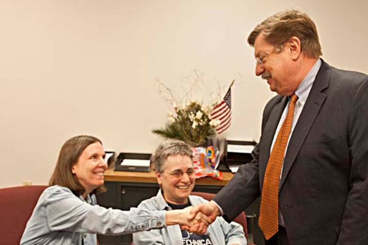 D. Bruce Hanes, the Montgomery County register of wills, shakes hands with Nikki Wade (left) and Rene Crystal while applying for their marriage license at the Register of Wills office in Montogmery County on the first day same sex couples could apply. ( RON TARVER / Staff Photographer ) May 28 2014