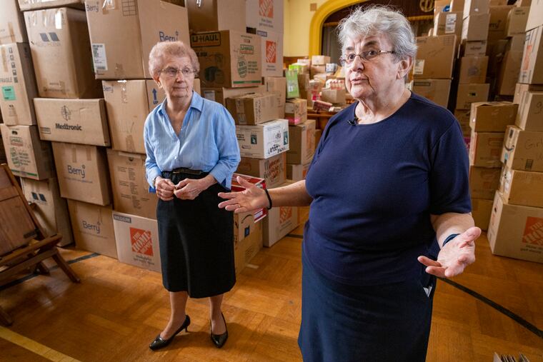 Sister Dorothy Ann Busowski (left) and Sister Joann Sosler of the Sisters of St. Basil in Jenkintown, with donations waiting for shipment to assist Ukrainians.