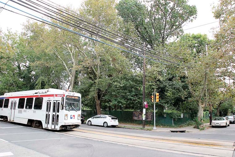 Developers seeking to build a larger-than-allowed apartment building on Baltimore Ave. and 43rd St. in West Philly's Spruce Hill neighborhood asked the community to help with the design.A SEPTA trolley goes by the site on Baltimore Ave. on Sept. 9, 2013. ( CHARLES FOX / Staff Photographer )
