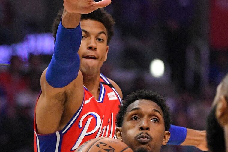 Los Angeles Clippers guard Lou Williams, below, tries to shoot as Philadelphia 76ers guard Matisse Thybulle defends during the first half of an NBA basketball game Sunday, March 1, 2020, in Los Angeles. (AP Photo/Mark J. Terrill)