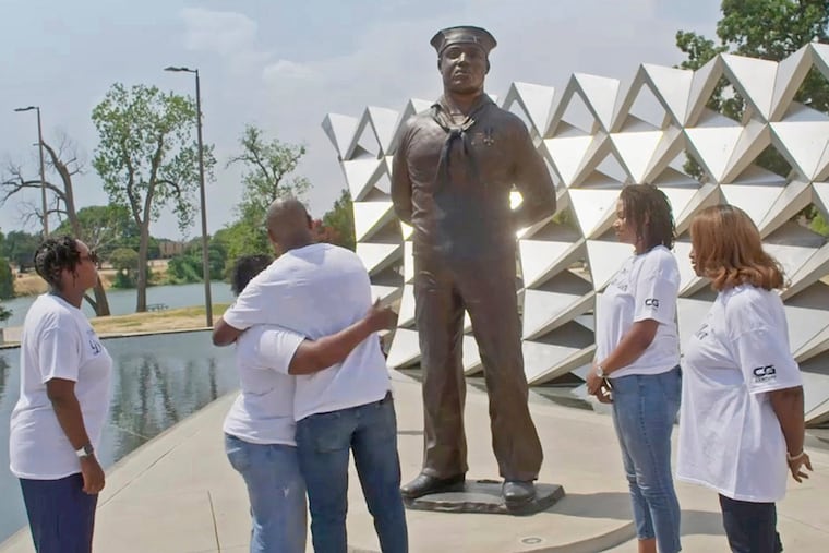 This image released by National Geographic shows family members surrounding a memorial honoring mess attendant Doris Miller in Waco, Texas in 2024. Miller shot down enemy planes during the attack on Pearl Harbor and was the first Black service member to be honored with the Navy Cross.