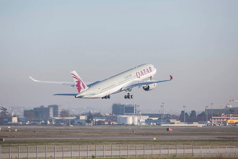 Qatar Airways Ltd.'s first Airbus A350 passenger aircraft takes off following a delivery ceremony at the Airbus Group NV factory in Toulouse, France, on Dec. 22, 2014. ( Balint Porneczi / Bloomberg )