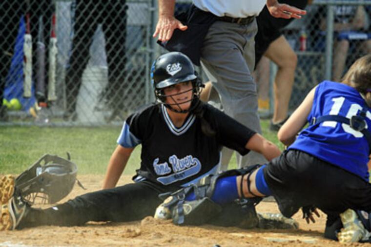 Toms River's Alyssa Paul is safe at home during the second inning as Williamstown catcher Chrissy Tamburrino is unable to make the tag. (Akira Suwa / Staff Photographer)