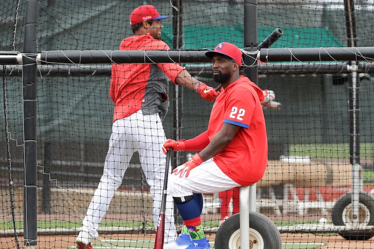 Phillies Andrew McCutchen takes a seat while teammate Nick Williams takes his turn during batting practice before the Phillies played the Blue Jays in a spring training game.