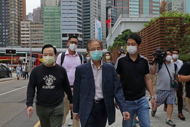 Former pro-democracy lawmaker Martin Lee, 81-year-old, center, leaves a police station in Hong Kong, Saturday, April 18, 2020. Hong Kong police arrested at least 14 pro-democracy lawmakers and activists on Saturday on charges of joining unlawful protests last year calling for reforms.