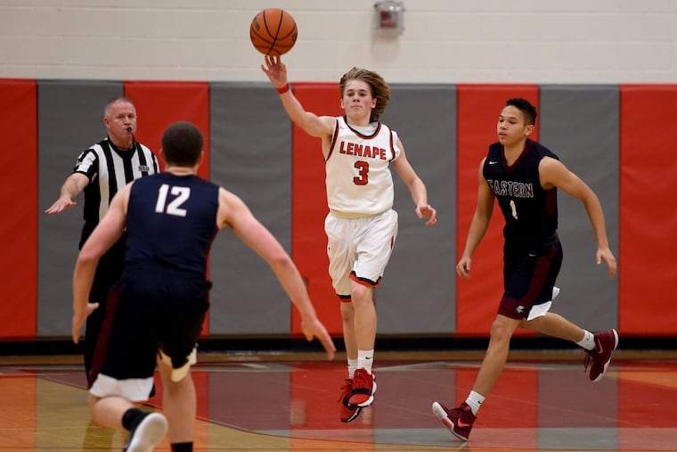 Lenape's Matt Ingersoll (#3) passes off between Eastern's Ryan Ems (left) and Troy Edwards (right) February 6, 2018. TOM GRALISH / Staff Photographer