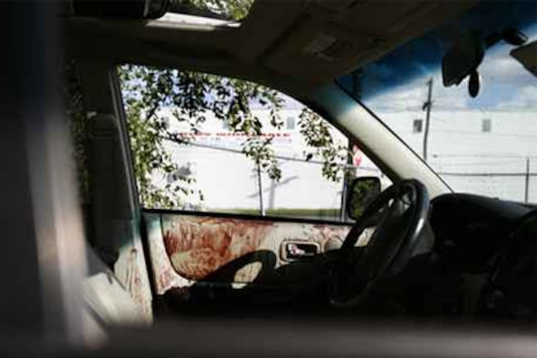 The interior of the vehicle that Thomas Timko was driving when he was shot Sunday. He remained in critical condition last night. (Eric Mencher / Staff Photographer)