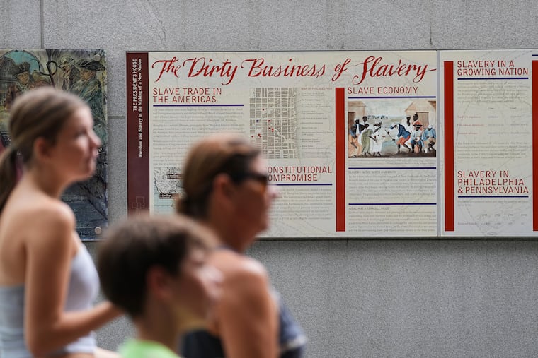 FILE - People walk past an informational panel at President's House Site Tuesday, Aug. 19, 2025, in Philadelphia. (AP Photo/Matt Rourke, File)