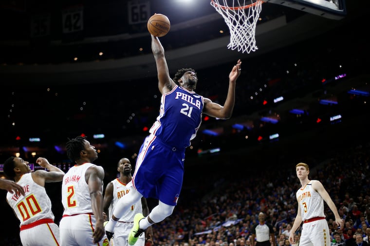 76ers center Joel Embiid goes up for a dunk against the Atlanta Hawks in Philadelphia, in this Monday, Feb. 24, 2020, file photo. The 76ers have kept their trust in Joel Embiid, who signed a four-year, $196 million contract extension.