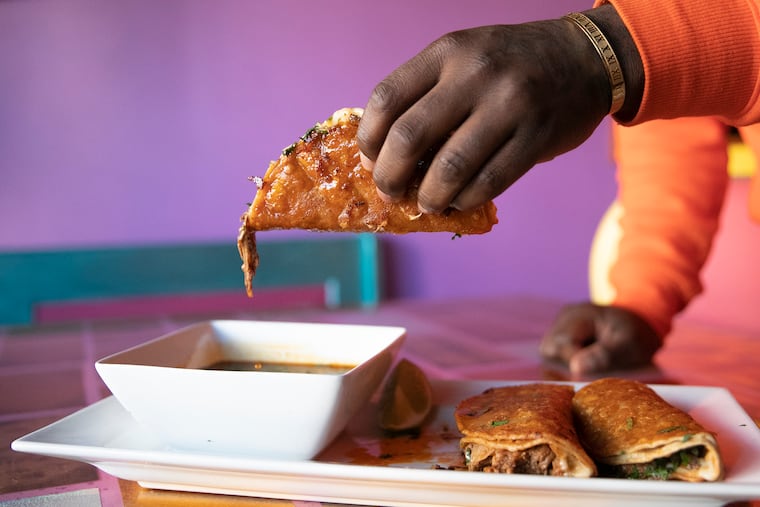 Birria beef tacos are dipped in consomme and photographed at chef Jennifer Zavala’s restaurant, Juana Tamale, on East Passyunk Ave. in South Philadelphia on Friday, Feb. 11, 2022. During the federal government shutdown that cutoff SNAP benefits to thousands of Philadelphians, Juana Tamale is offering free kids' meals to families affected.