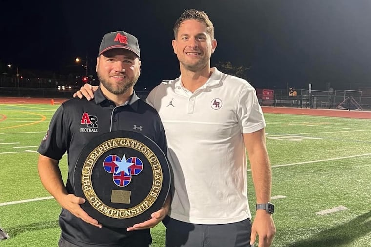 Mark Ostaszewski (left) with Archbishop Ryan athletic director Joe Zeglinski after the Raiders won the Philadelphia Catholic League Blue Division title last season.