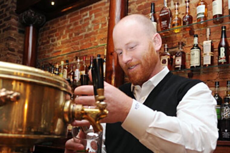 Lemon Hill owner Mike Welsh draws a beer.