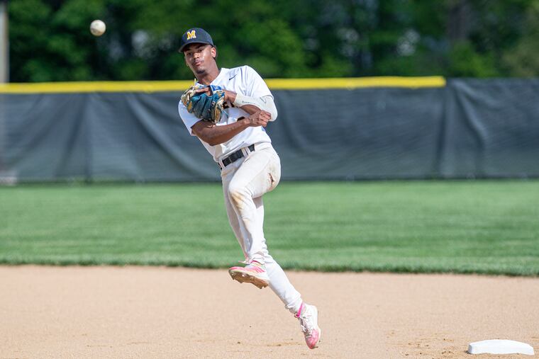 Moorestown High shortstop Maximus Martin throwing to first base during a home game against Kingsway on May 12.