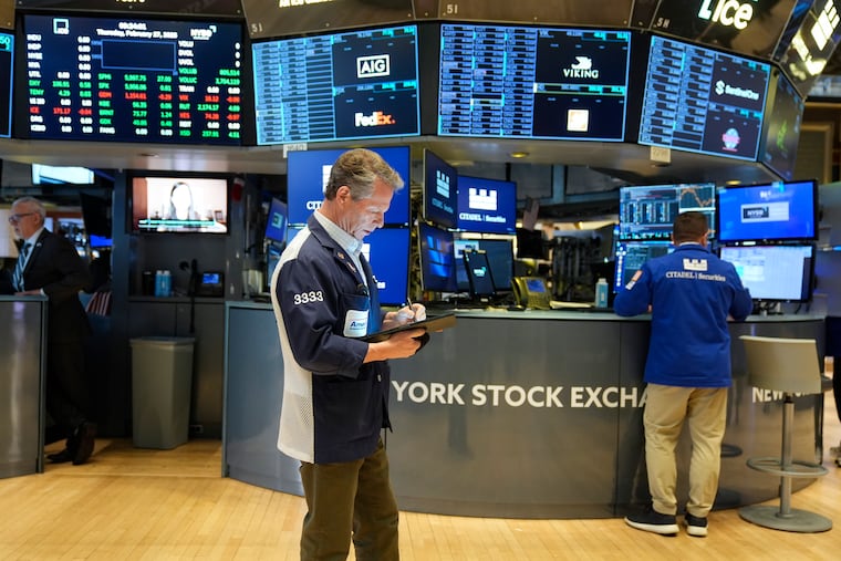 People work on the floor at the New York Stock Exchange.