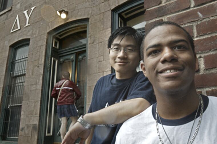 Steven Vaughn-Lewis (right) outside the Delta Upsilon house at the University of Pennsylvania with best friend and fraternity brother Jin Guan. They are planning a trip to China to attend a wedding. (David M. Warren / Staff Photographer)