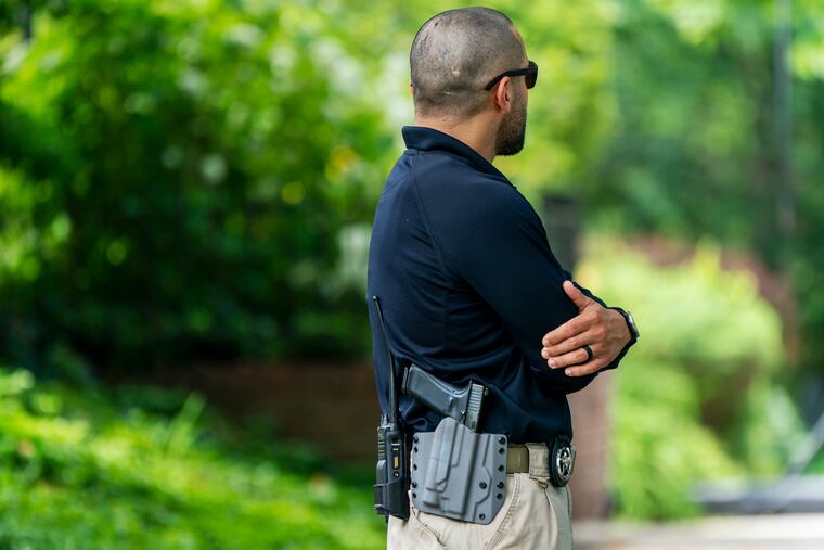 A U.S. Marshal patrols outside the home of Supreme Court Justice Brett Kavanaugh, in Chevy Chase, Md., on June 8, 2022.