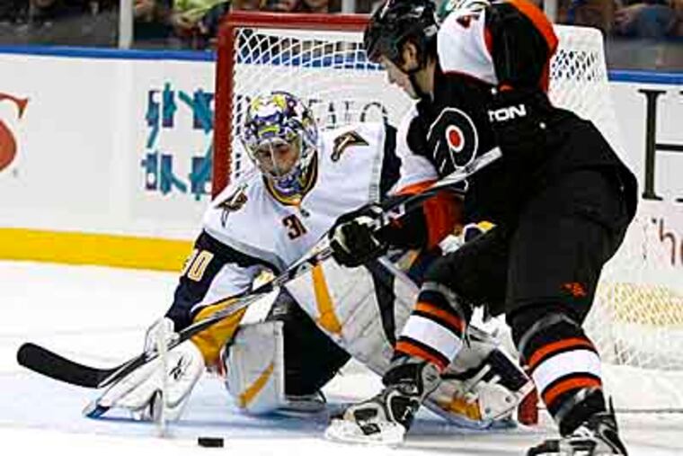 Buffalo Sabres goalie Ryan Miller makes a save on a shot by Philadelphia Flyers' Arron Asham (45) during the second period of the NHL hockey game in Buffalo, N.Y. (AP Photo/ David Duprey)