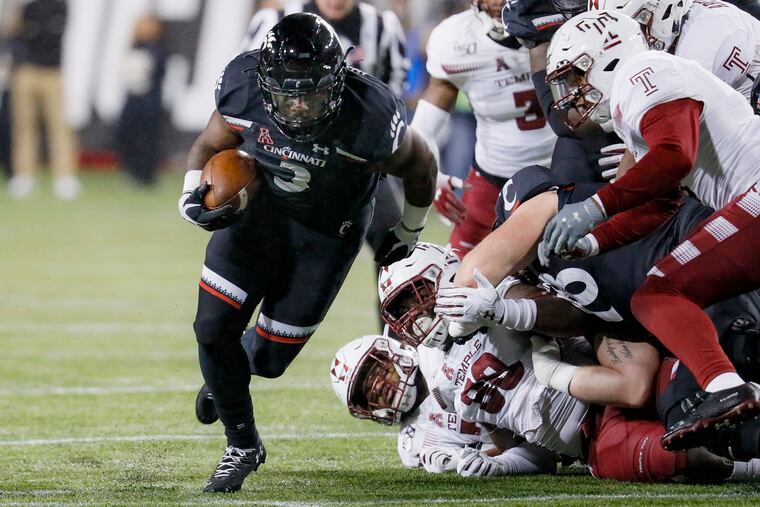 Cincinnati running back Michael Warren II (3) runs for a first down during the first half of an NCAA college football game against Temple, Saturday, Nov. 23, 2019, in Cincinnati. (AP Photo/John Minchillo)