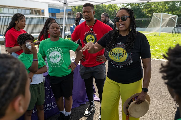 The author, the founder and CEO of Open Door Abuse Awareness and Prevention, gives a speech on healthy lifestyle choices at a youth football clinic at Mastery Charter School in Germantown last June.