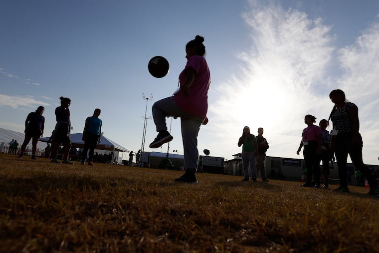 Immigrants play soccer at a holding center for migrant children in Carrizo Springs, Texas, July 9, 2019. Currently fewer than 2,500 unaccompanied minors are in federal custody, federal data shows.