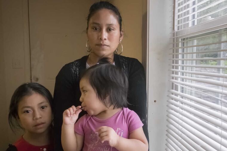 Hever Cuac Domingo, 23, an undocumented worker from Guatemala, was arrested after a traffic stop in Chester County and is now in York Prison. Here, From their Avondale apartment, his wife, Loida, and their daughters Jendy, 7 and Esli, 20 months, have a view of the mushroom farm where their life began to unravel.