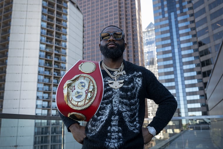 Jaron "Boots" Ennis poses with his IBF welterweight championship belt on Thursday.