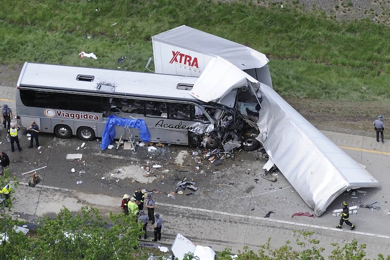 Authorities investigate the scene of a fatal collision between a tractor-trailer and a tour bus on Interstate 380 near Mount Pocono on June 3, 2015. (AP Photo/David Kidwell)