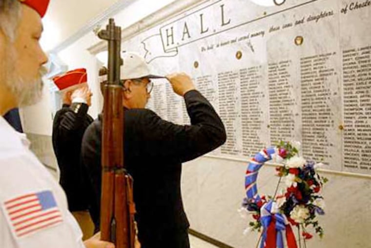 Mayor of West Chester Richard B. Yoder, left, and Anthony J. Polito salute the Hall of Heroes at a ceremony held in the Chester County Courthouse May 18.