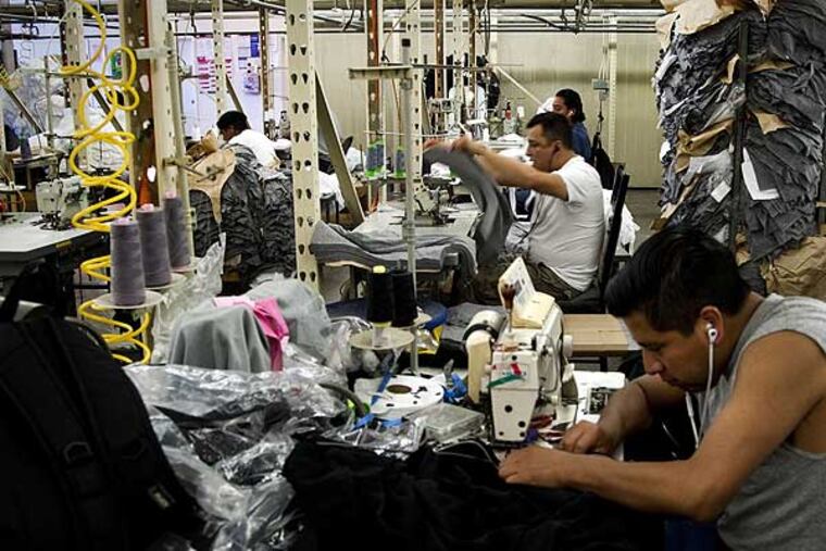 Workers sew T-shirts at Los Angles, California, apparel firm Venley. Despite the higher production costs, the company's owner refuses to send work overseas and produces everything locally. (Gina Ferazzi/Los Angeles Times/MCT)