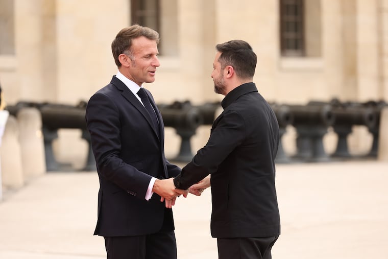 French President Emmanuel Macron greets Ukrainian President Volodymyr Zelensky ahead of the Coalition of the Willing summit on security guarantees for Ukraine at the Hotel des Invalides in Paris, France, Monday, July 13, 2026.