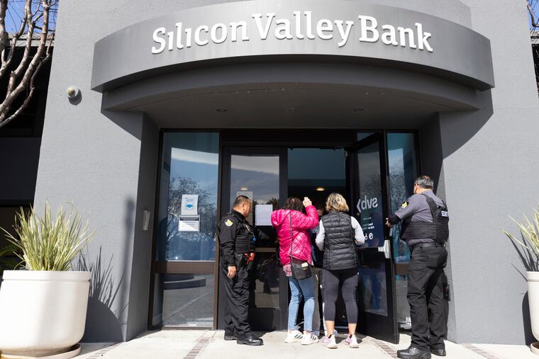 Security guards open Silicon Valley Bank's headquarters in Santa Clara, Calif., on Monday. Federal officials Sunday secured funds for depositors to withdraw after the bank's collapse.