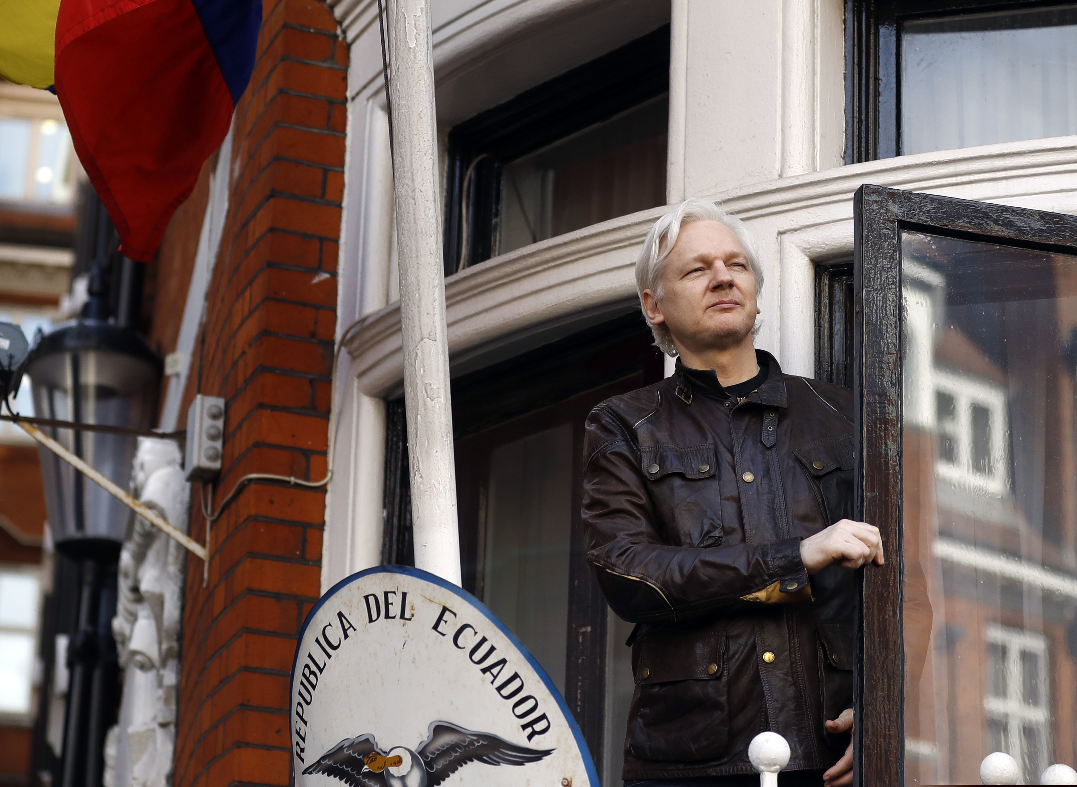 In this Friday, May 19, 2017 file photo, WikiLeaks founder Julian Assange looks out from the balcony while claiming political asylum at the Ecuadorian embassy in London.