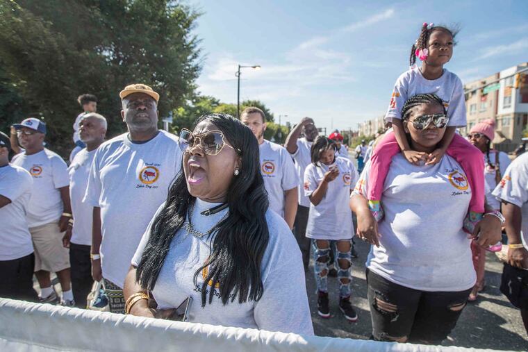 Janet Elam (center) of the International Longshoremens Association, Local 1291, yells words of support for her union as they march down Columbus Boulevard on Monday, Sept. 4, 2017, as part of the Philadelphia Labor Day Parade.