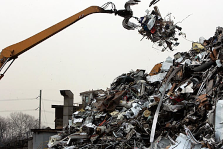 Crushed metal is added to the pile at the foot of the Platt Memorial Bridge. The plan: Move operations to Eddystone. (Laurence Kesterson / Staff Photographer)