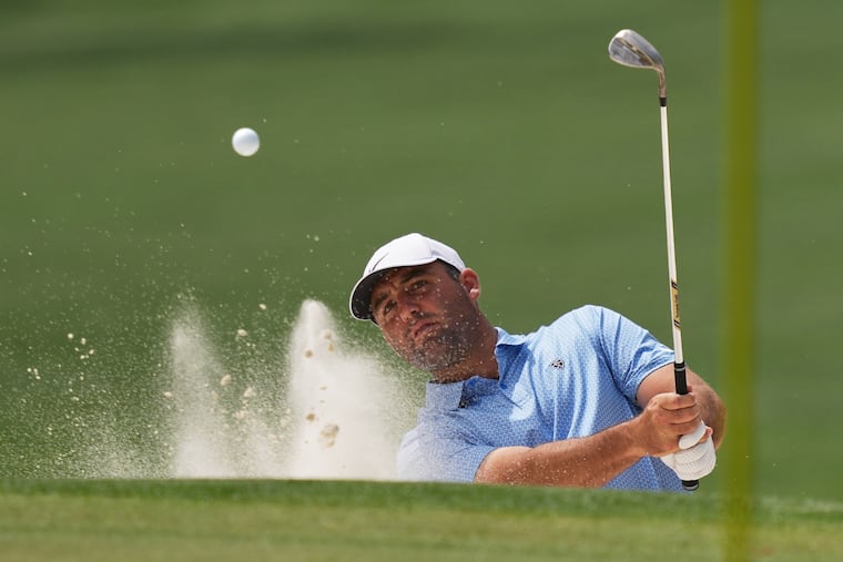 Scottie Scheffler hits from a bunker during a practice round ahead of the Masters. He has been tinkering with his swing.