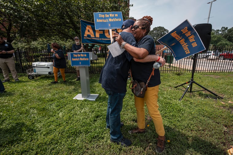 Ira Kedson, the president of AFGE local 310 at the Coatesville V.A. Medical Center, left, greets Karen Ford-Woods, right, president of AFGE Local 1793, which represents employees at the VA Medical Center in West Philly and other area facilities.