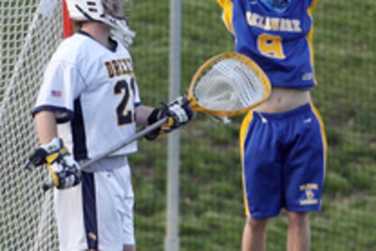 Goalie Bruce Bickford watches Hens' Phil Rollins celebrate goal.