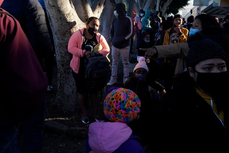 A woman seeking asylum in the United States waits with others for news of policy changes in Tijuana, Mexico.