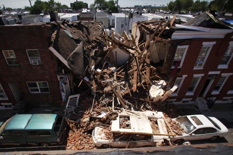 The scene of a rowhome explosion along the 400 block of Daly Street in South Philadelphia on July 29, 2013. (LUKE RAFFERTY / Staff Photographer)