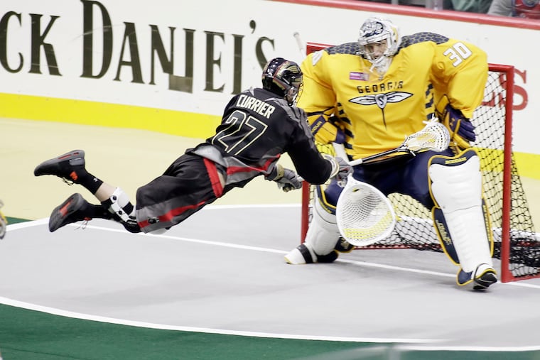 The Wings' Josh Currier scores on Swarm goalie Mike Poulin in the second quarter on Saturday.